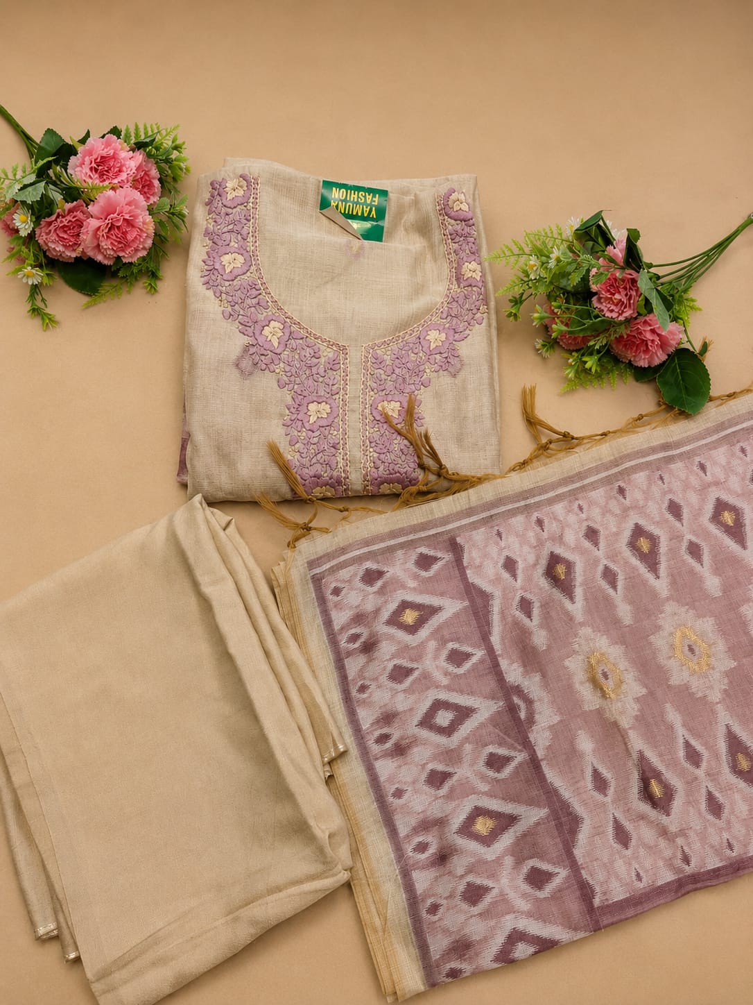 Elegant embroidery meets the comfort of linen cotton in this off-white and purple unstitched suit.