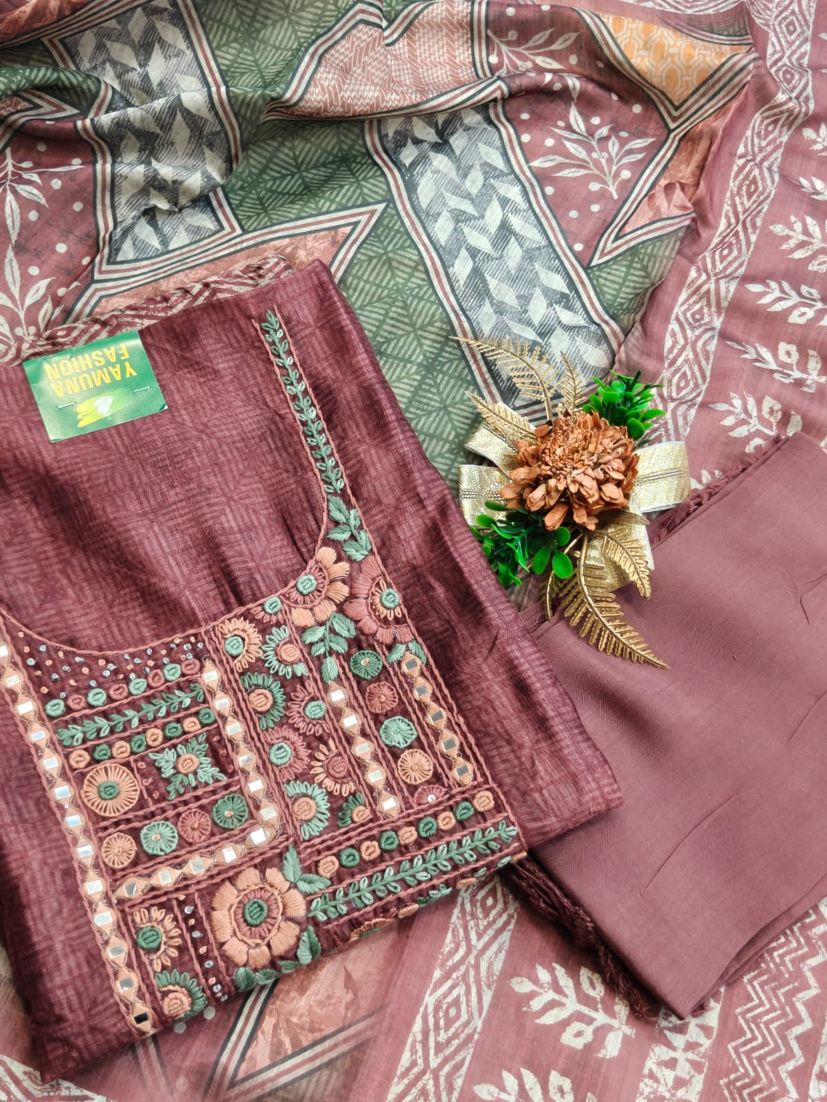 Elegant embroidery meets the comfort of linen cotton in this off-white and purple unstitched suit.