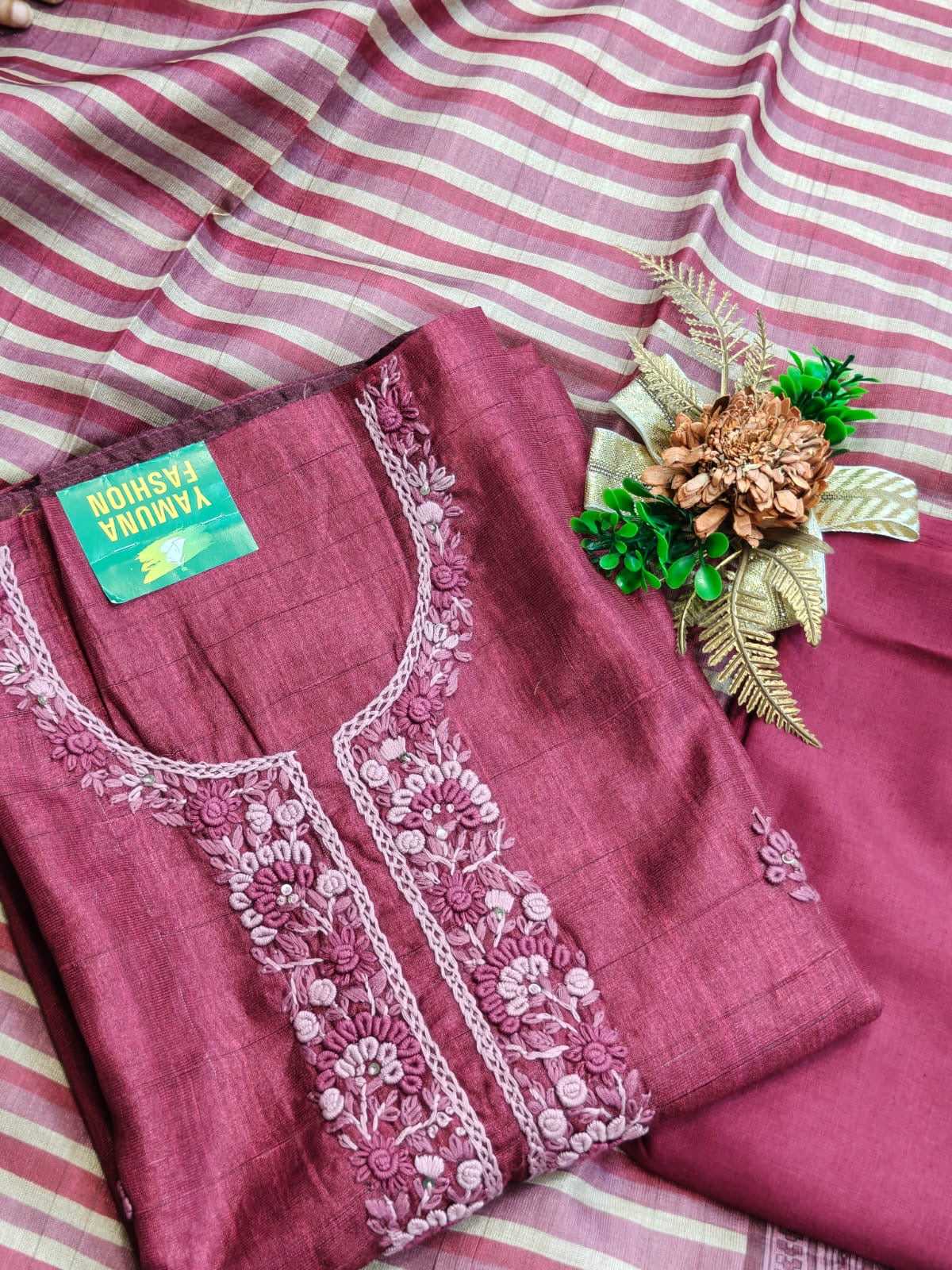 Elegant embroidery meets the comfort of linen cotton in this off-white and purple unstitched suit.